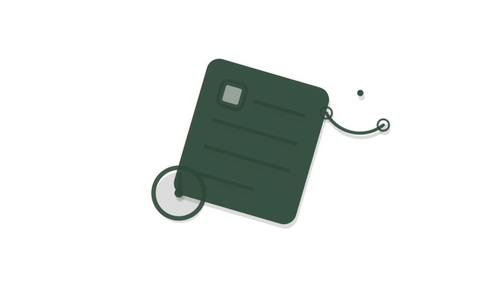 A wooden laptop block with a brass asset tag beside an open booklet, showing an IT question answered or ticketed.
